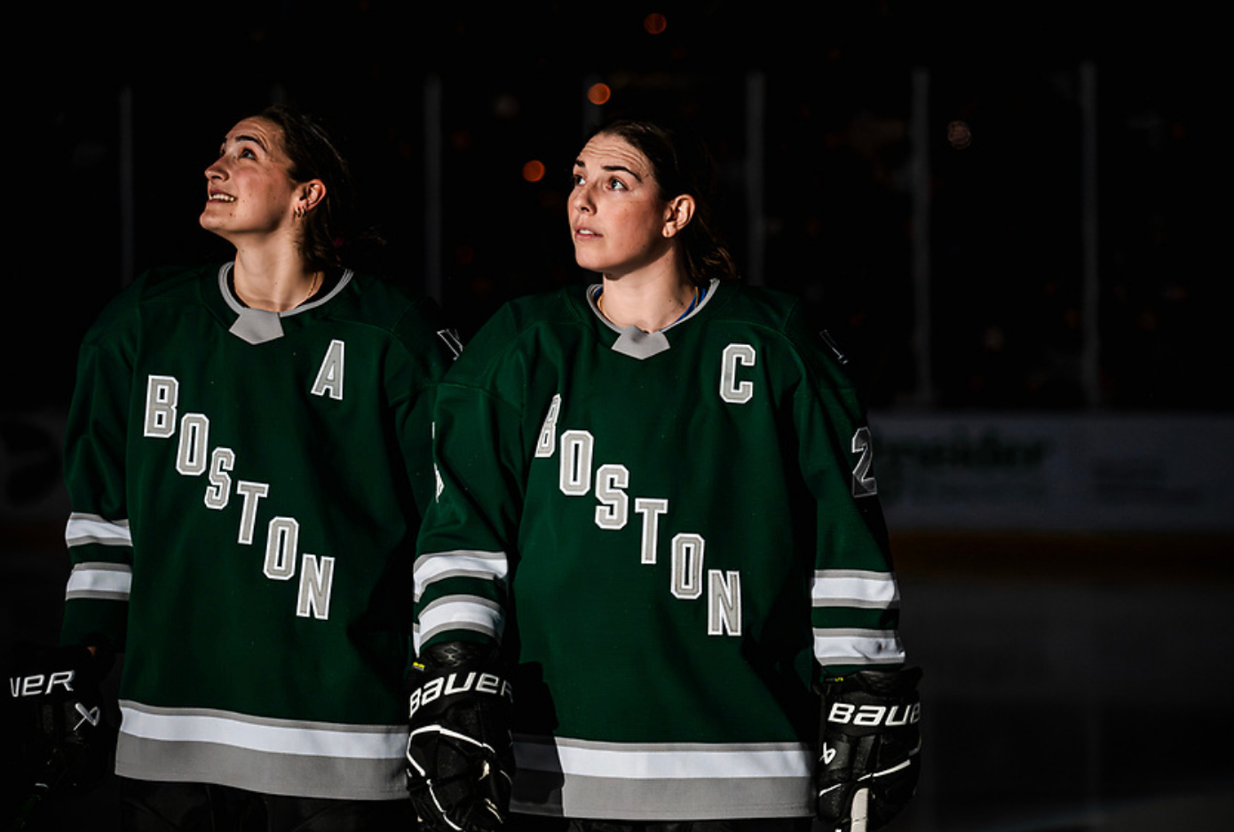 Keller and Knight stand shoulder to shoulder wearing green home jerseys. They're both looking up and to the right.