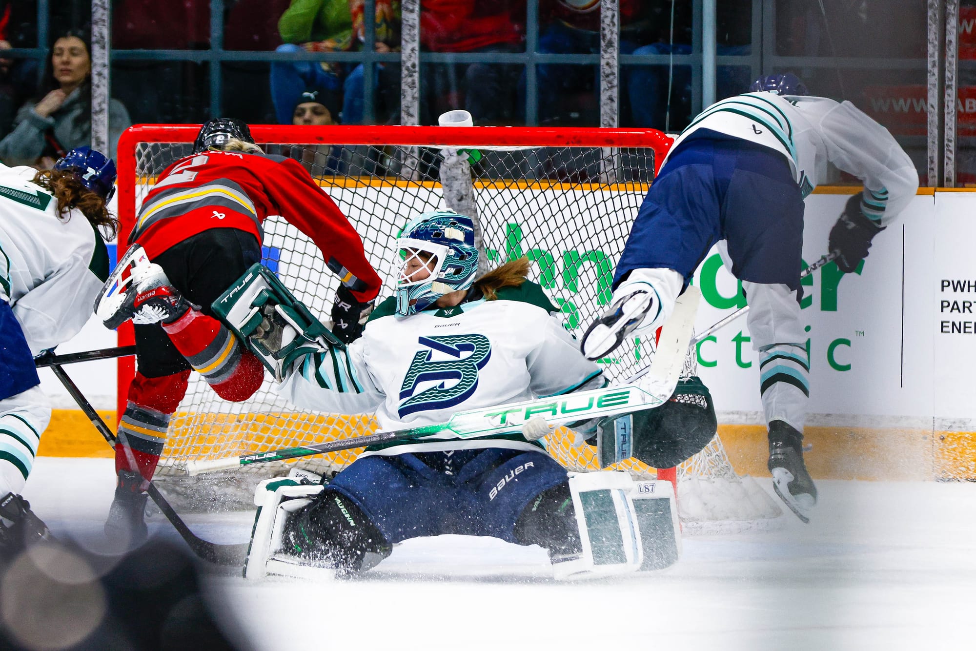 A Charge player (left in red) and a Fleet player (right in white) collide simultaneously with Frankel (middle in white) at the goal.