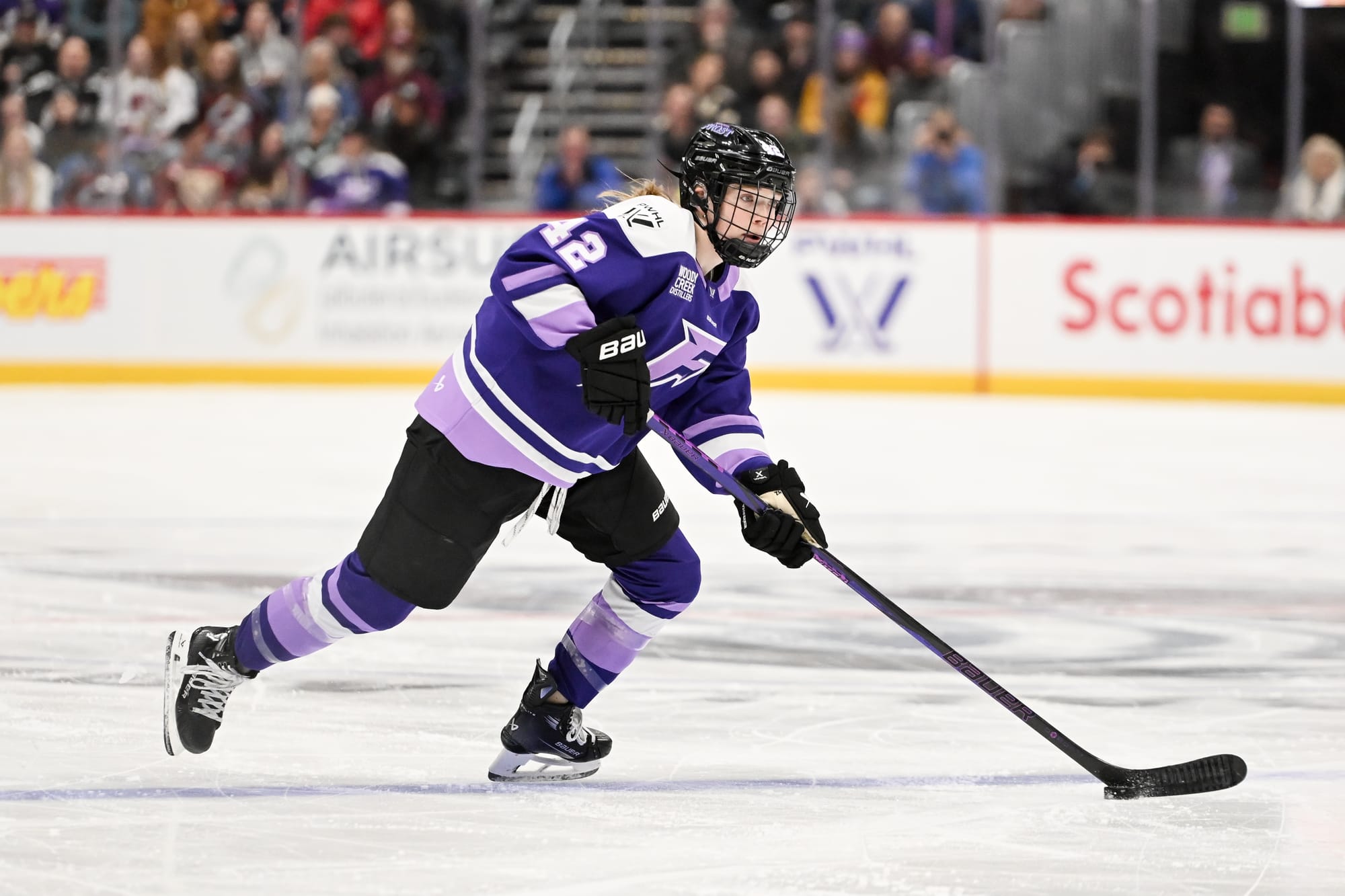 Claire Thompson carries the puck