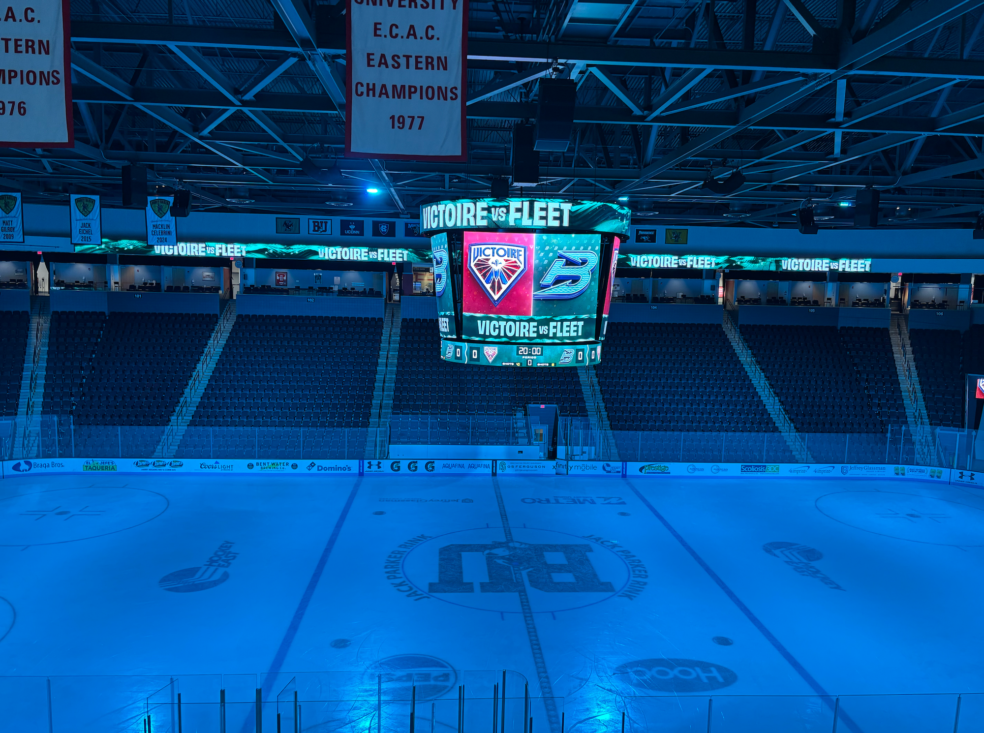 A shot of the ice at Aggani Arena, along with the jumbotron displaying graphics with the Victoire and Fleet logos.