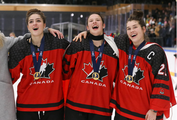 Ava Murphy, Emmalee Pais, and Jocelyn Amos celebrate a Gold Medal Win at the 2023 U18 WHC's