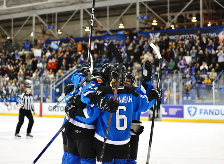 Five Toronto players celebrate a goal with a tight group hug. They are all wearing blue home uniforms.