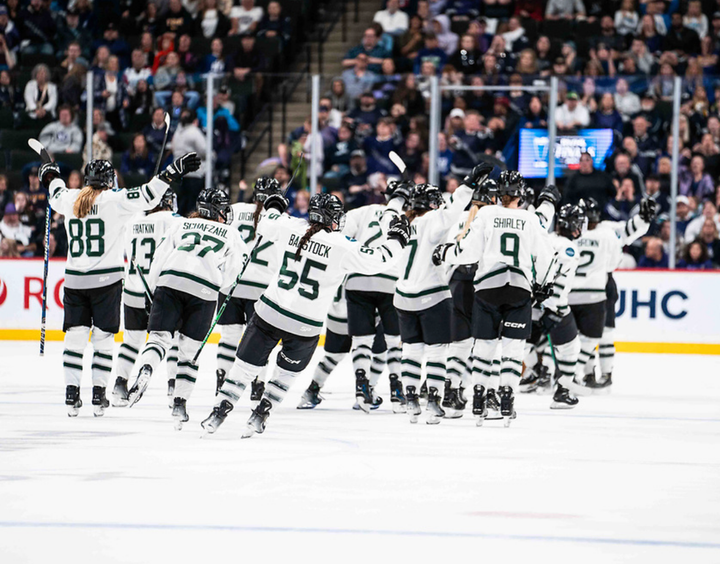 Boston celebrates a win with their backs to the camera. All of them are wearing white away uniforms.