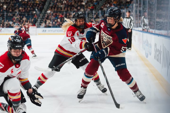 Ottawa Charge and Montreal Victoire battle along boards | Photo Cred: Professional Women's Hockey League