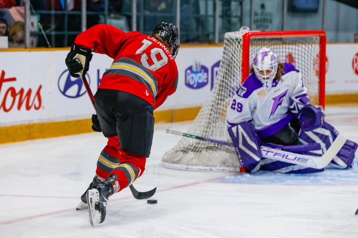 Brianne Jenner breaks in on Nicole Hensley with the puck.